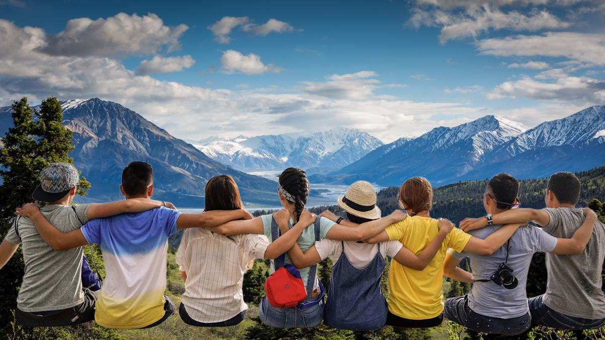 Group photograph composited over a mountain background